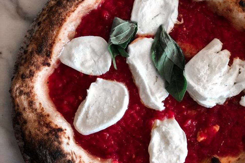 Tomato, mozzarella and basil pizza before baking